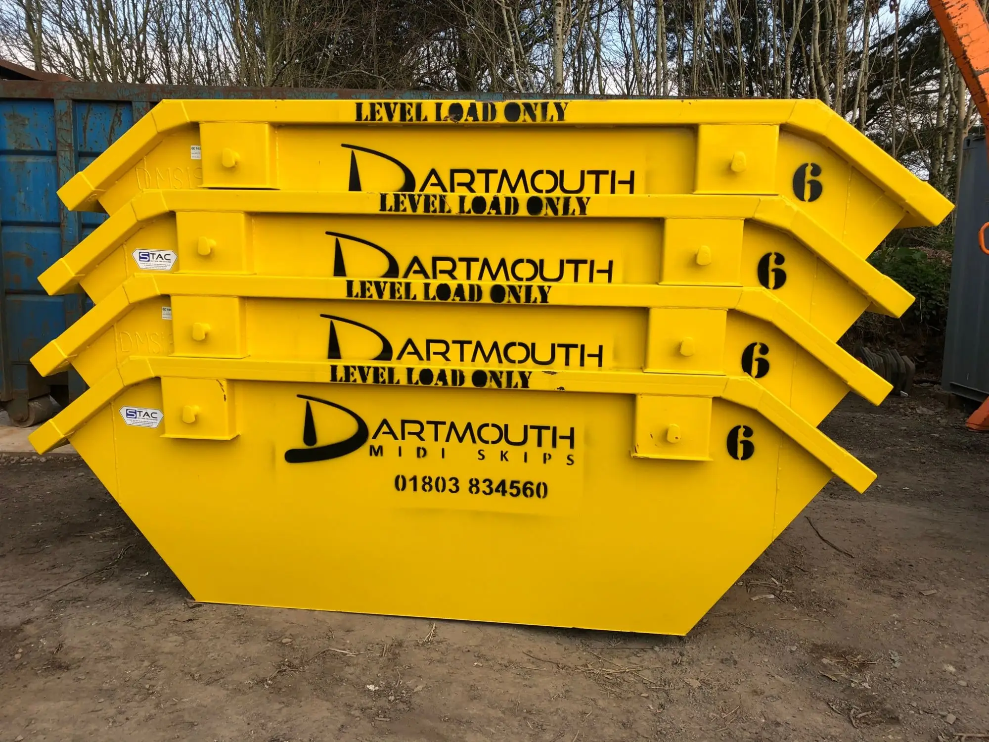 Stack of yellow 6 yard builders skips Dartmouth Midi Skips Dartmouth